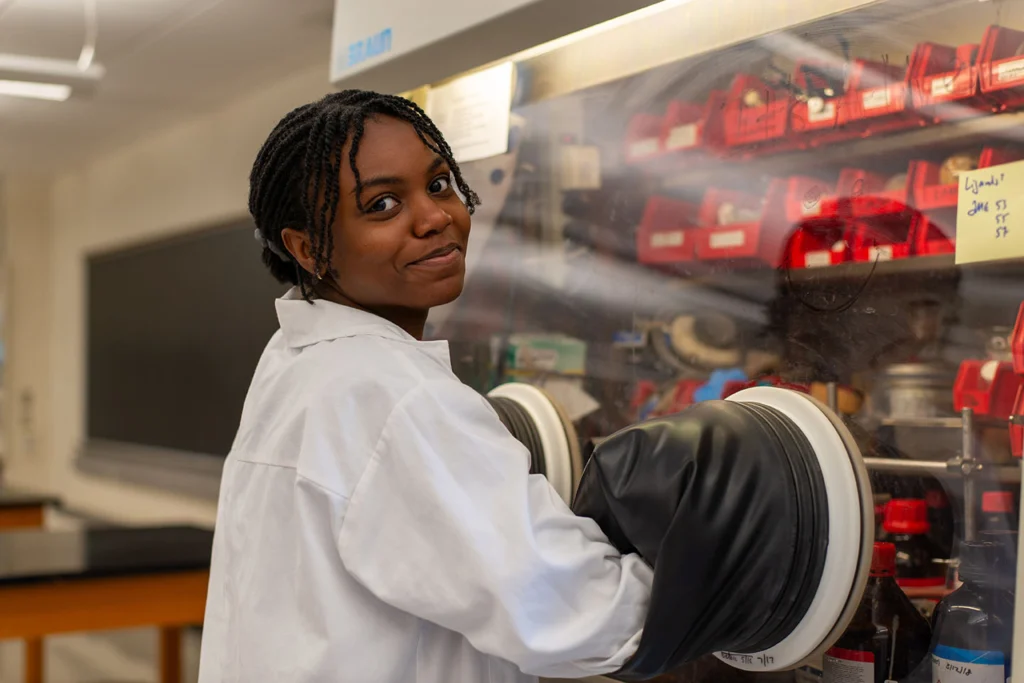 A student works in a chemistry glove box