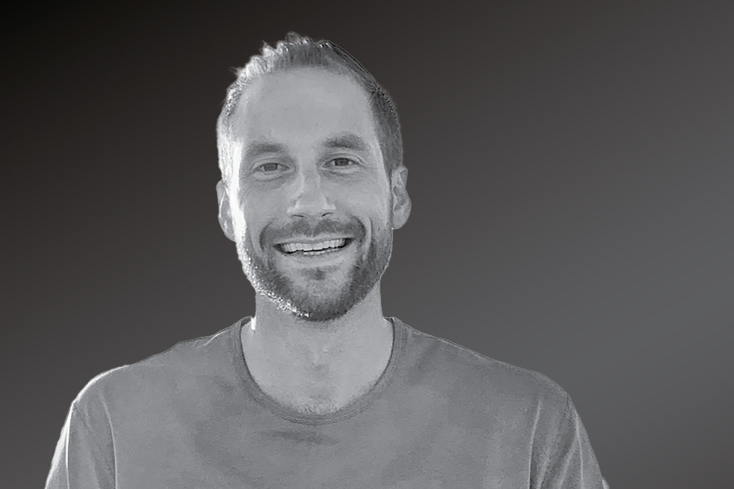 A black-and-white headshot of Spencer Liddic